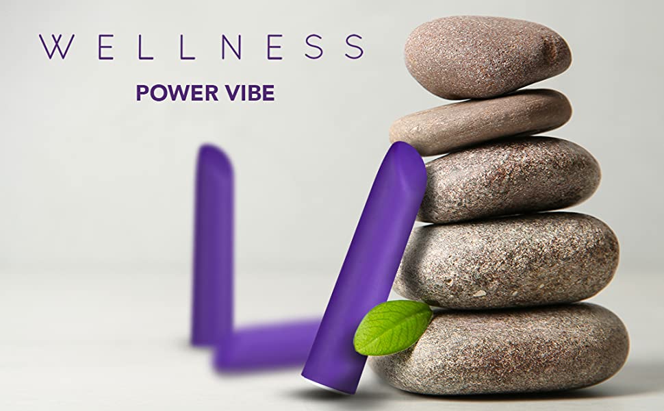 wellness power vibe vibrator next to stack of rocks